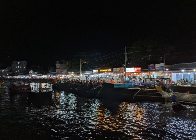 Nam Du Island wharf area at night with people eating next to the water