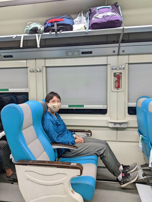 Jackie Szeto, Life Of Doing, sits on an Executive class reclining seat on the train from Surabaya to Yogyakarta, Indonesia