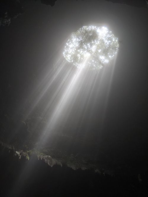 Light rays peering into the top of Jomblang Cave