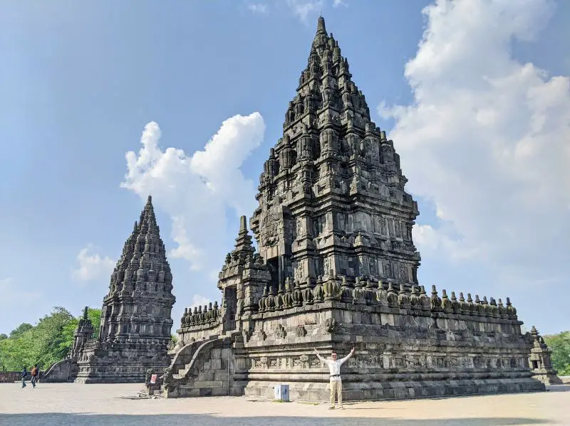 Justin Huynh, Life Of Doing, has hands up and stands in front of one of the temples at Prambanan Temple