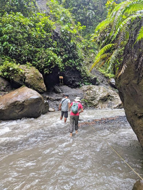 Jackie Szeto, Life Of Doing, and guid walk across a stream to go to Tumpak Sewu Waterfall