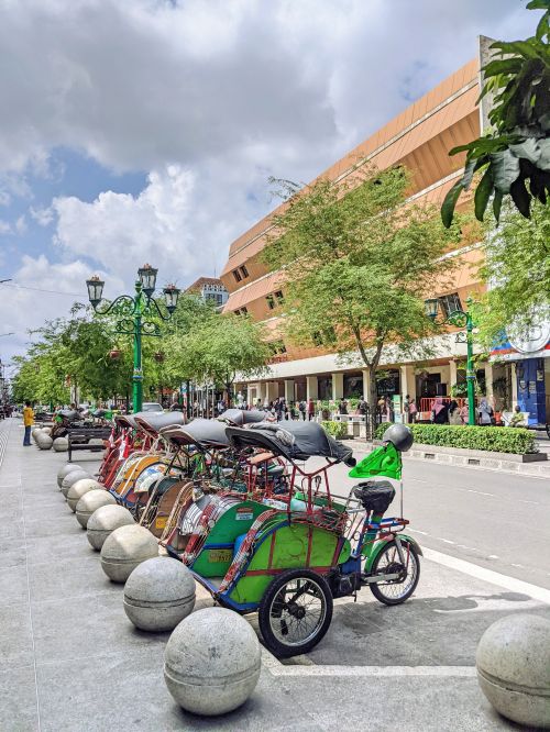 Colorful cyclos waiting for tourists along Malioboro Street in Yogyakarta, Indonesia