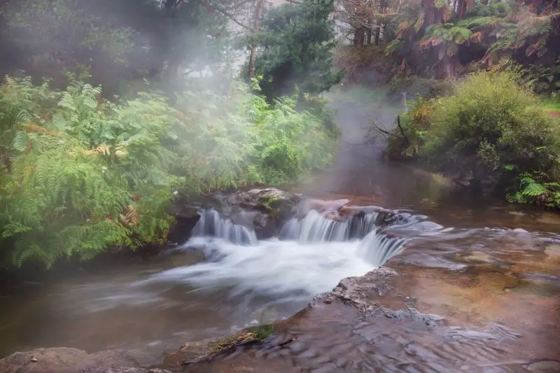 A small waterfall at a natural hot spring at Kerosene Creek, Rotorua, New Zealand