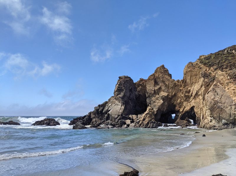 A natural rock cliff next to the ocean at Pfeiffer Beach