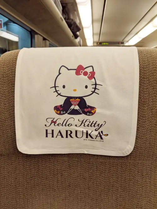 A Hello Kitty themed head cover for the seats in the Haruka Airport Limited Express train