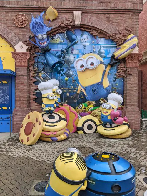 Street art of a group of yellow minions from the Minions movie playing with food at Univeral Studios Japan