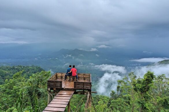 Justin Huynh and Jackie Szeto, Life Of Doing, sit on a chair with Mount Agung in the background at Lahangan Sweet