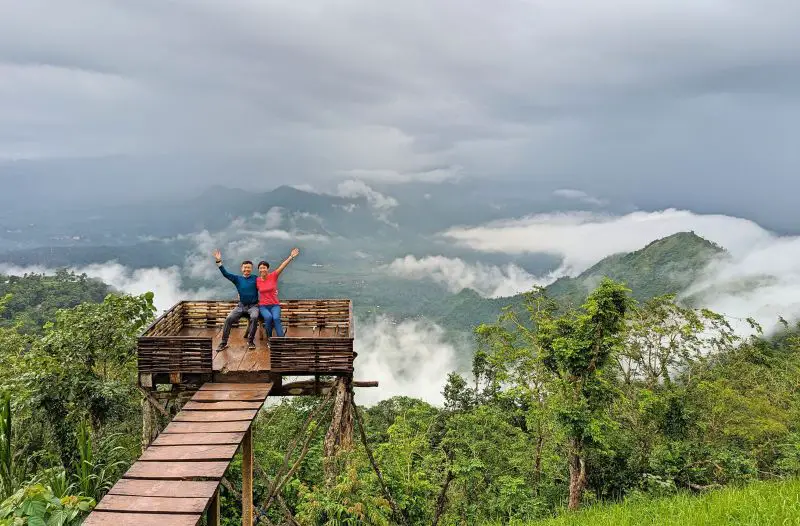 Justin Huynh and Jackie Szeto, Life Of Doing, has their hands up with Mount Agung in the background at Lahangan Sweet