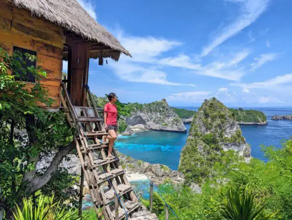 Jackie Szeto, Life Of Doing, stands on the wooden staircase of Rumah Pohon treehouse in Nusa Penida