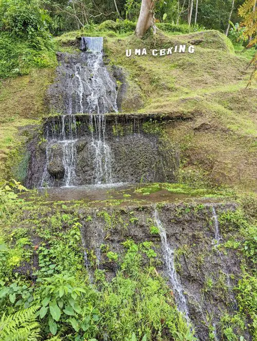 A waterfall next to the Uma Ceking signage