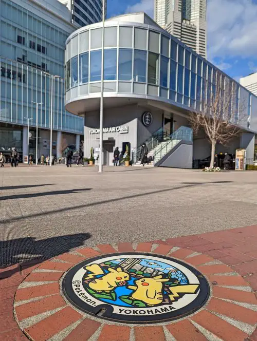 A manhole cover with two Pikachu, yellow pika in the Pokemon anime, in Yokohama