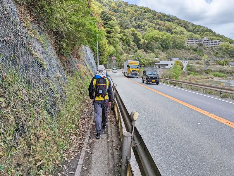 Justin Huynh, Life Of Doing, walks next to the street as he is heading to the starting point of Old Fukuchiyama Trail