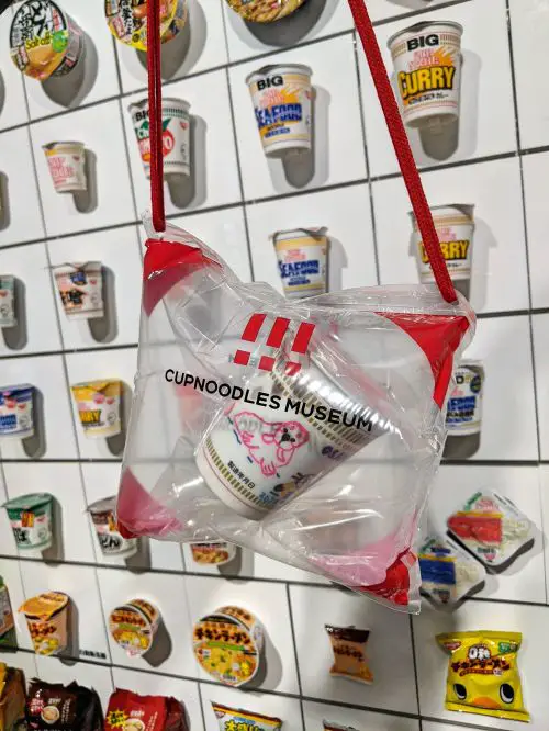 A customized Cup Noodles inside an inflated bag against the wall of Nissin branded instant noodles at Cup Noodles Museum Osaka in Ikeda