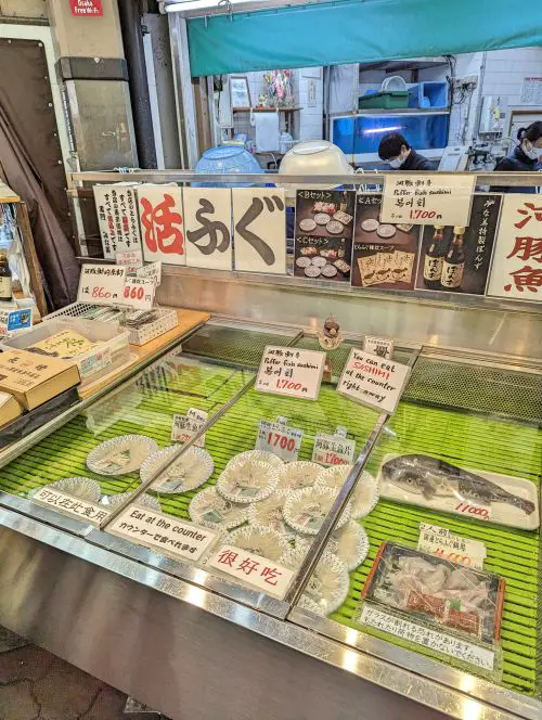 A refrigerator with puffer fish (fugu) sashimi for sale at Kuromon Market, Osaka