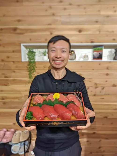 Justin Huynh, Life Of Doing, hold up a box of tuna nigiri from the supermarket