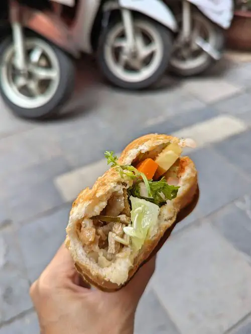 Inside of the mixed vegan Vietnamese sandwich with pickles, mushrooms, and other vegetarian filling at Banh Mi Chay Vietnam in Hanoi