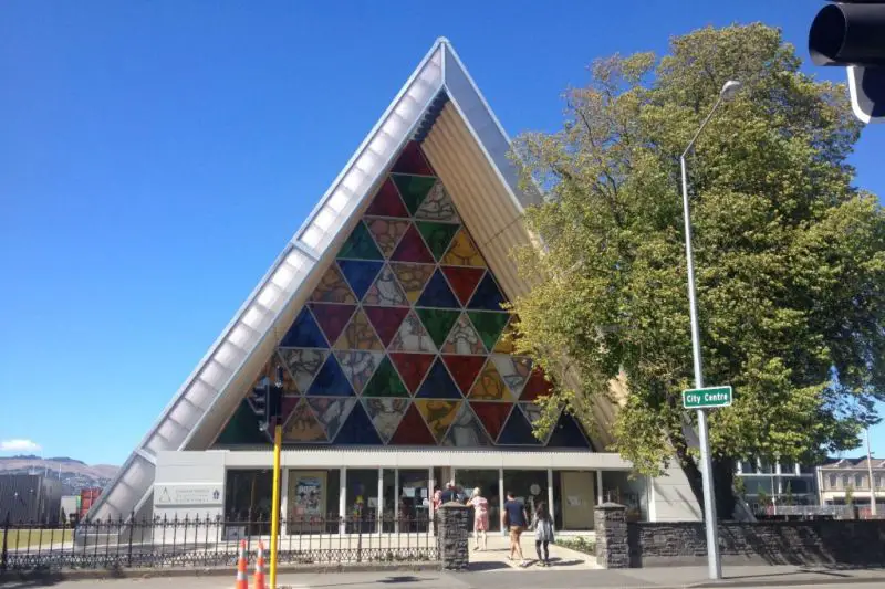 A triangle shaped cathedral with colorful triangle stained glass at Cardboard Cathedral in Christchurch, New Zealand