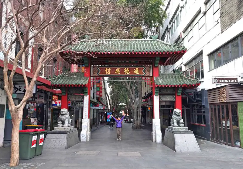 Jackie Szeto, Life Of Doing, stand underneath Sydney's Chinatown red gate and lion statues