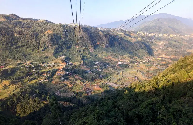 View of outer Sapa town with green mountains and rice terraces from the Fansipan cable car