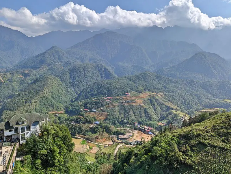 A white mansion surrounded by green mountains and rice terraces in Sapa, Vietnam