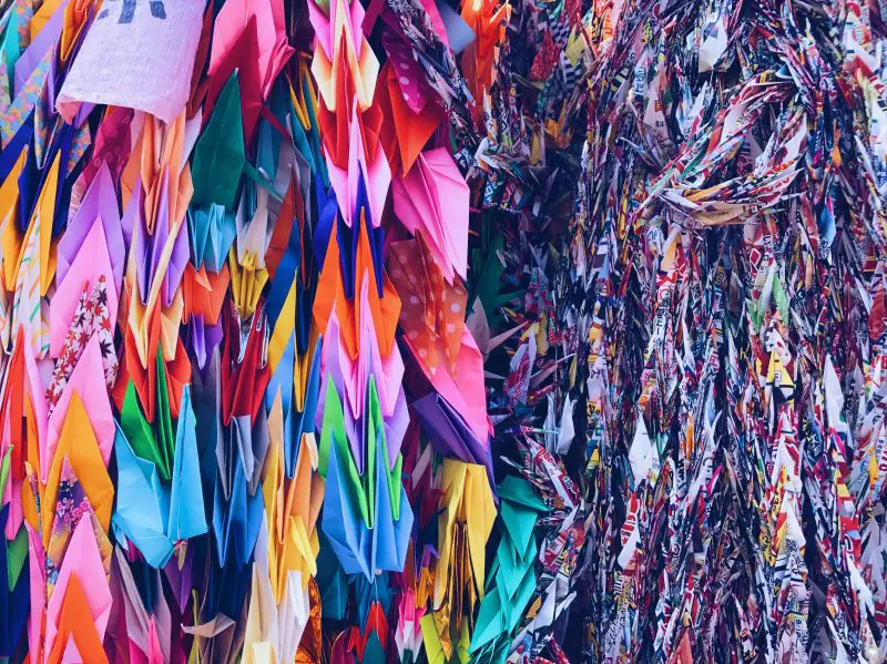 Colorful folded paper cranes at a memorial wall in Hiroshima, Japan
