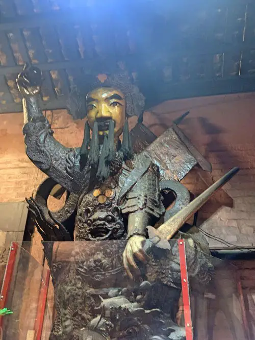 A statue of a God holding a sword at Jade Emperor Pagoda in Ho Chi Minh City, Vietnam
