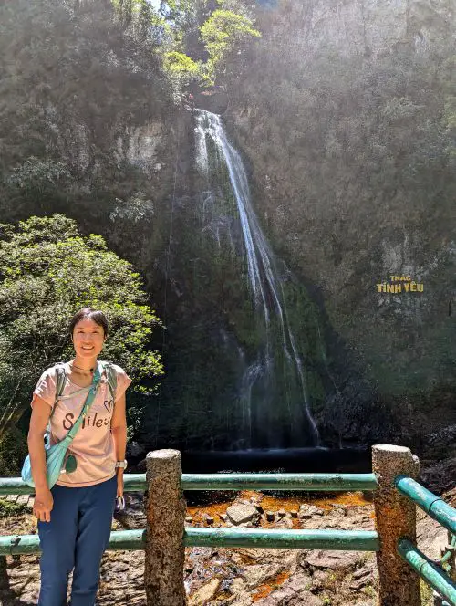 Jackie Szeto, Life Of Doing, is located at the viewing platform and takes a photo next to Love Waterfall