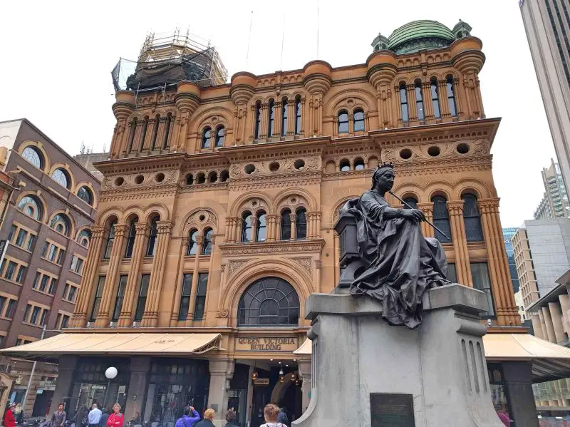 The statue of Queen Victoria and a beige Queen Victoria Building at Sydney, Australia