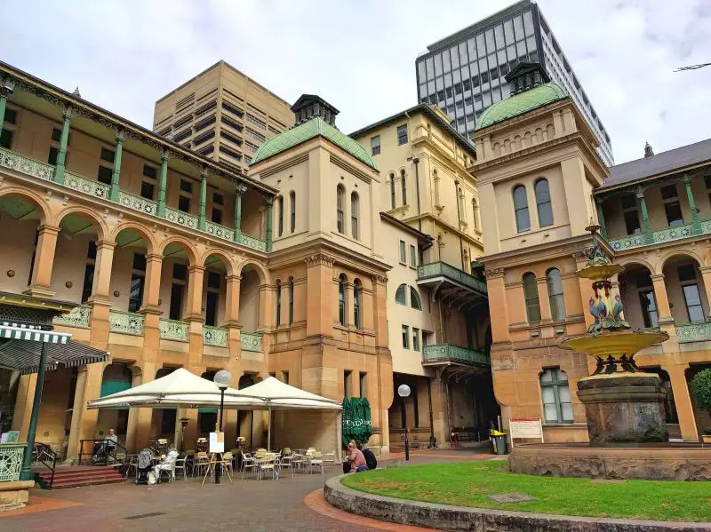 View of the courtyard with tables and chairs and the decorative Sydney Hospital