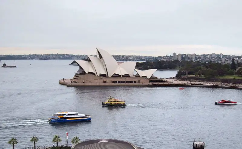 A view of the Sydney Opera House and boats from the Sydney Harbour Bridge