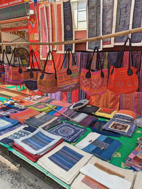 Handicrafts such as embroidered bags, scarves, pillowcases, and more for sale at Bac Ha Market