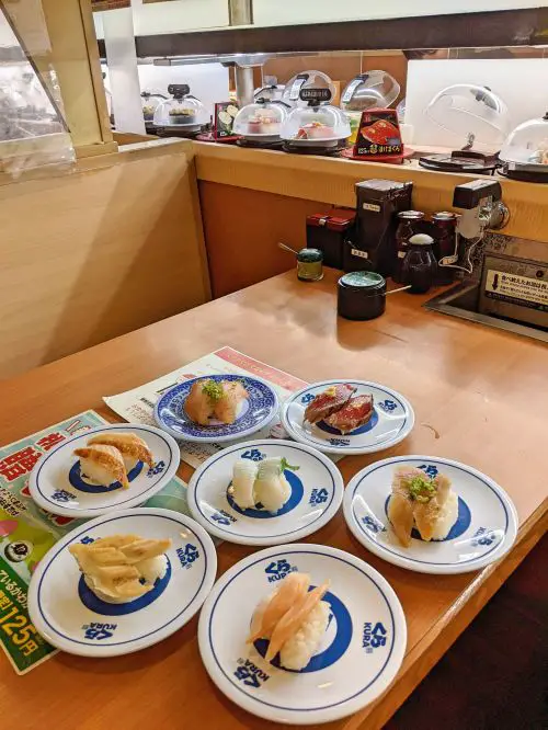 Seven plates of sushi at Kura Sushi, a recommended place to eat conveyor belt sushi in Japan
