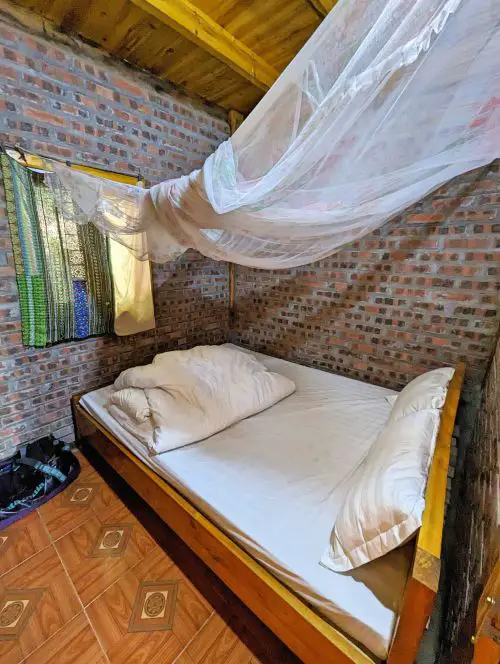 A bedroom with a mosquito net at Mama Si Homestay in Sapa, Vietnam