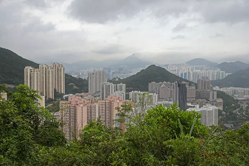 Views of tall apartment buildings along the Dragon's Back trail in Hong Kong