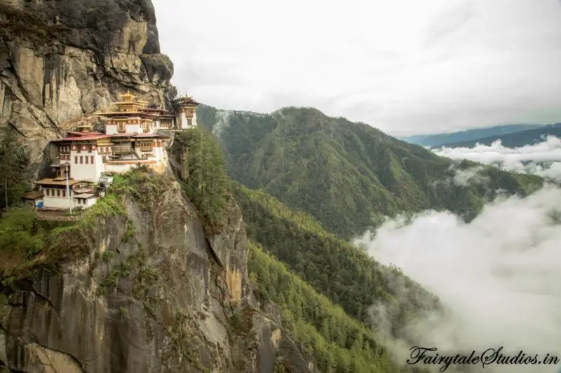 Taktsang Monastary in Bhutan sits on the edge of the rocky cliffs while the clouds roll in
