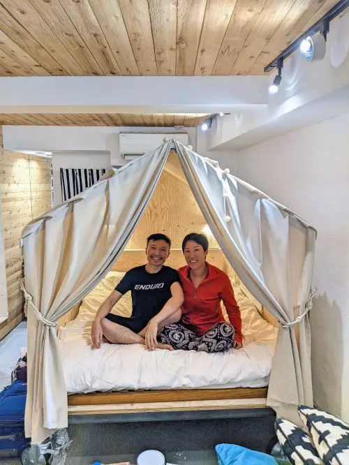 Justin Huynh and Jackie Szeto, Life Of Doing, sitting inside their glamping bed at an Airbnb in Japan