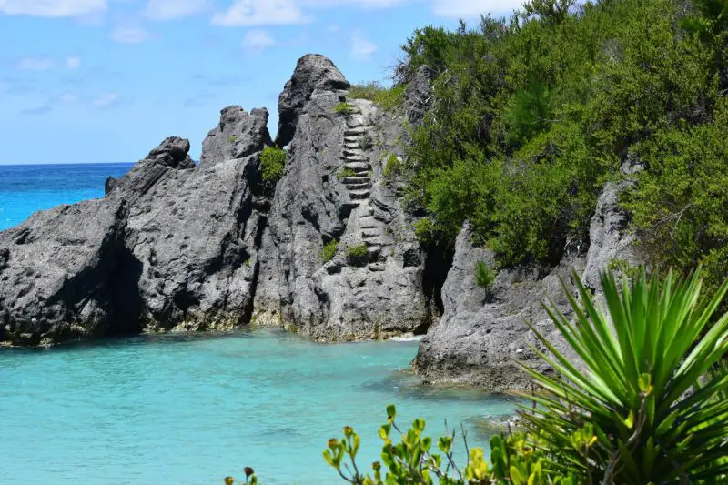 Steps on a rocky area that leads to turquoise ocean water in Bermuda