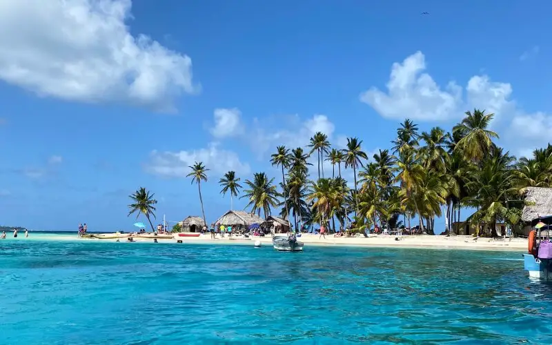 Palm trees lined along a white sandy beach of San Blas Islands, Panama