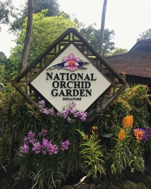 A diamond shaped sign with National Orchid Garden Singapore printed on it