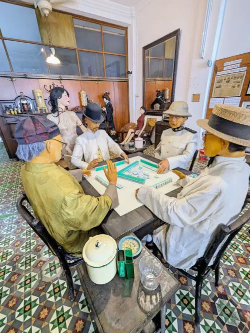 Mannequins of gentlemen playing a game of mah jong at the Han Chin Pet Soo Tour