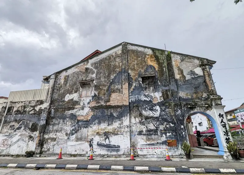 Dilapidated wall art of tin mining history in Ipoh, Malaysia