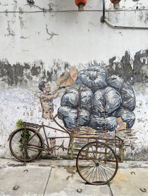 A wall art of a man collecting garbage on his trishaw in Ipoh, Malaysia