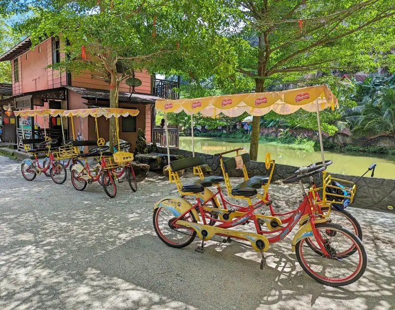 Pedal bikes for 2 or 4 people parked on the side of the walkway at Qing Xin Ling Leisure and Cultural Village