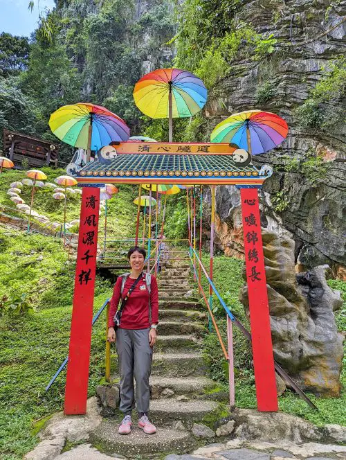 Jackie Szeto, Life Of Doing, stands under a red gate for the mini hike at Qing Xin Ling Leisure and Cultural Village