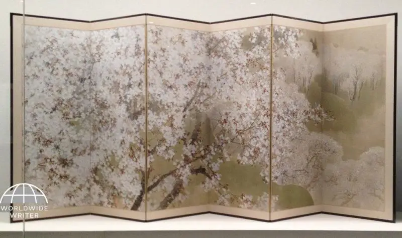A painted screen of pink cherry blossoms on display in the National Museum of Modern Art