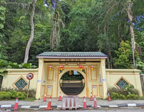 A gate with a circle in the middle and painted in pale yellow with golden yellow trimmings is the entrance to Moongate Station 5 hiking trail
