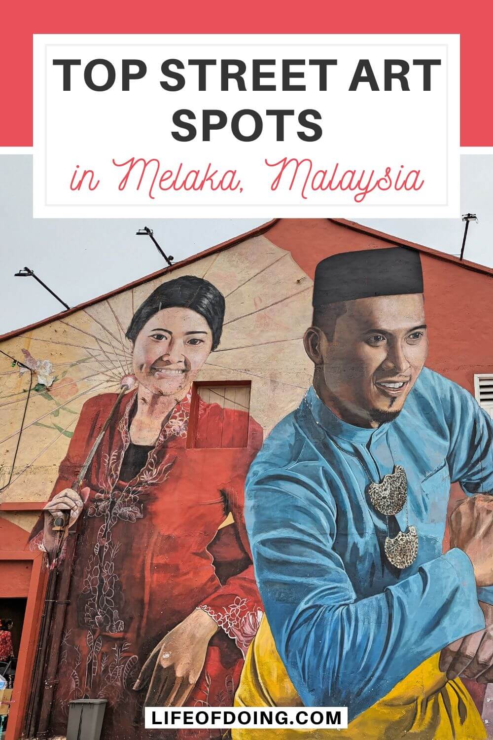A large wall mural of a Malaysian woman wearing a red traditional dress and a man wearing a light blue and yellow outfit at Melaka, Malaysia