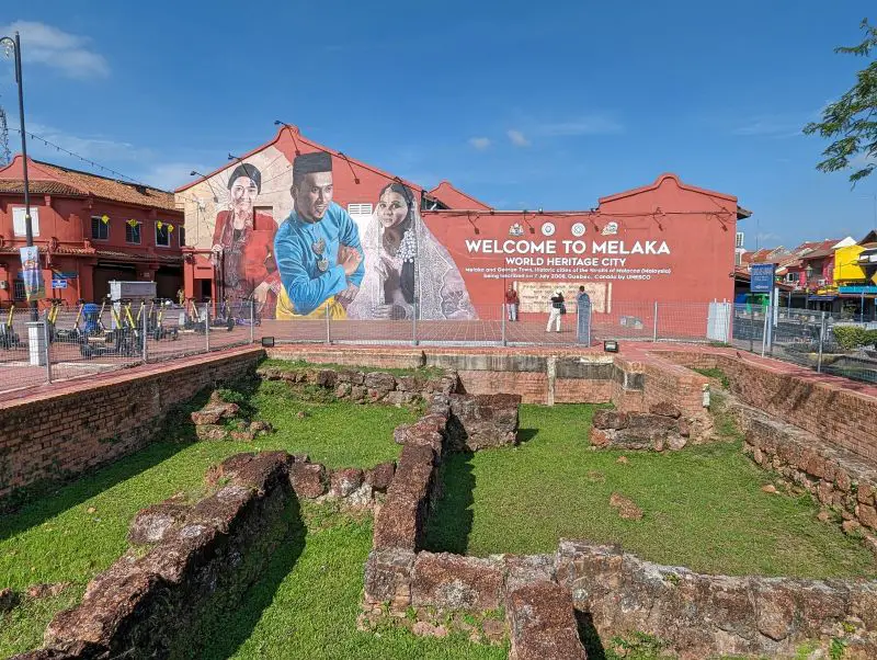 Old ruins of a former building in front of the Melaka World Heritage City wall art in Melaka, Malaysia