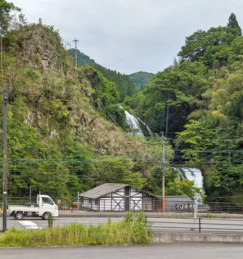 A truck passing by the small Jionnotaki Waterfall