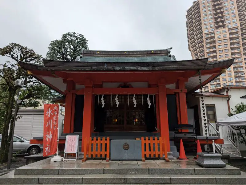 A red orange praying building at Azabu Hikawa Shrine in Tokyo, Japan